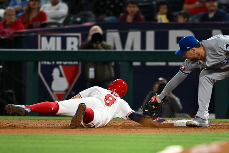 May 11, 2024; Anaheim, California, USA; Kansas City Royals first baseman Vinnie Pasquantino (9) tags Los Angeles Angels shortstop Zach Neto (9) during the seventh inning at Angel Stadium. Mandatory Credit: Jonathan Hui-USA TODAY Sports