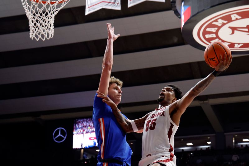 Feb 21, 2024; Tuscaloosa, Alabama, USA; Alabama Crimson Tide guard Aaron Estrada (55) shoots as Florida Gators center Micah Handlogten (3) defends during the first half at Coleman Coliseum. Mandatory Credit: Butch Dill-USA TODAY Sports