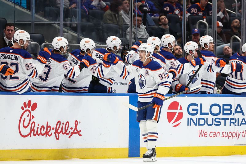 Oct 16, 2025; Elmont, New York, USA; Edmonton Oilers center Ryan Nugent-Hopkins (93) celebrates with his teammates after scoring a goal in the second period against the New York Islanders at UBS Arena. Mandatory Credit: Wendell Cruz-Imagn Images