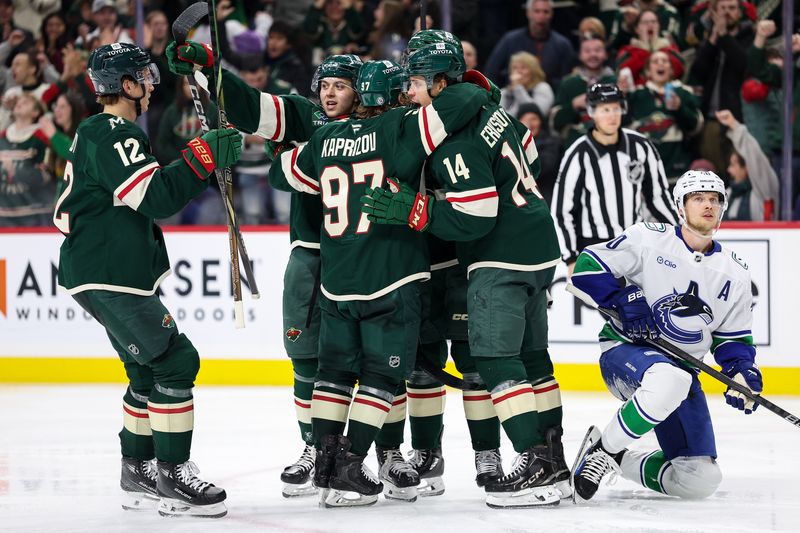 Dec 3, 2024; Saint Paul, Minnesota, USA; Minnesota Wild defenseman Jake Middleton (5) celebrates his goal with teammates during the third period against the Vancouver Canucks at Xcel Energy Center. Mandatory Credit: Matt Krohn-Imagn Images