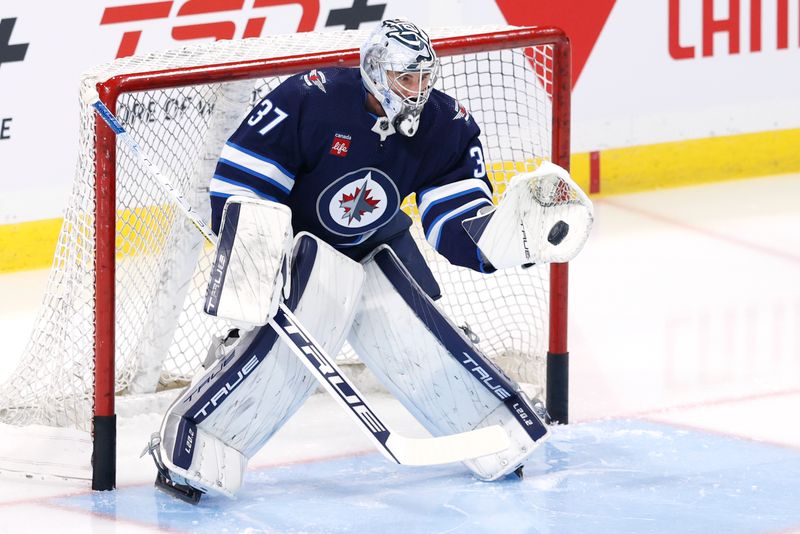 Oct 30, 2023; Winnipeg, Manitoba, CAN; Winnipeg Jets goaltender Connor Hellebuyck (37) warms up before a game against the New York Rangers at Canada Life Centre. Mandatory Credit: James Carey Lauder-USA TODAY Sports