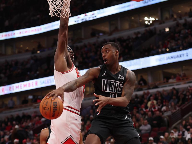 CHICAGO, ILLINOIS - DECEMBER 02: Dariq Whitehead #0 of the Brooklyn Nets passes around Jalen Smith #7 of the Chicago Bulls during the first half at the United Center on December 02, 2024 in Chicago, Illinois. NOTE TO USER: User expressly acknowledges and agrees that, by downloading and or using this photograph, User is consenting to the terms and conditions of the Getty Images License Agreement.  (Photo by Michael Reaves/Getty Images)