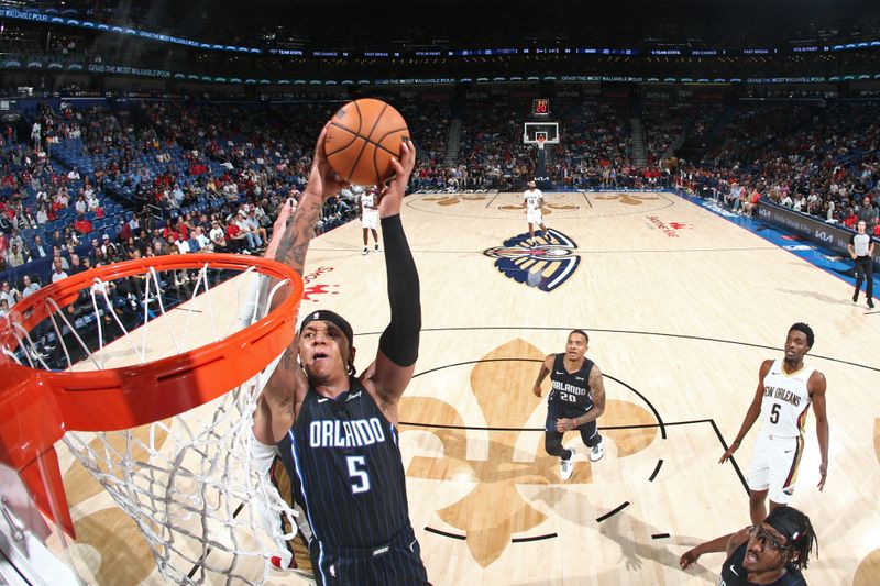 NEW ORLEANS, LA - OCTOBER 10: Paolo Banchero #5 of the Orlando Magic drives to the basket during the game against the New Orleans Pelicans on October 10, 2023 at the Smoothie King Center in New Orleans, Louisiana. NOTE TO USER: User expressly acknowledges and agrees that, by downloading and or using this Photograph, user is consenting to the terms and conditions of the Getty Images License Agreement. Mandatory Copyright Notice: Copyright 2023 NBAE (Photo by Layne Murdoch Jr./NBAE via Getty Images)