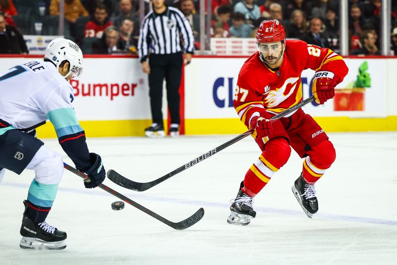 Dec 18, 2025; Calgary, Alberta, CAN; Calgary Flames right wing Matt Coronato (27) passes the puck against the Seattle Kraken during the second period at Scotiabank Saddledome. Mandatory Credit: Sergei Belski-Imagn Images
