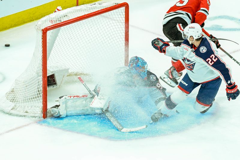 Mar 2, 2024; Chicago, Illinois, USA;  Columbus Blue Jackets defenseman Jake Bean (22) and Columbus Blue Jackets goaltender Elvis Merzlikins (90) defend against the Chicago Blackhawks during the third period at the United Center. Mandatory Credit: Matt Marton-USA TODAY Sports