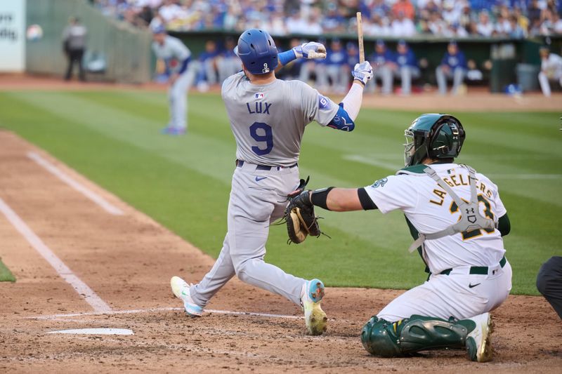 Aug 3, 2024; Oakland, California, USA; Los Angeles Dodgers infielder Gavin Lux (9) breaks his bat hitting a fly ball against the Oakland Athletics during the fifth inning at Oakland-Alameda County Coliseum. Mandatory Credit: Robert Edwards-USA TODAY Sports