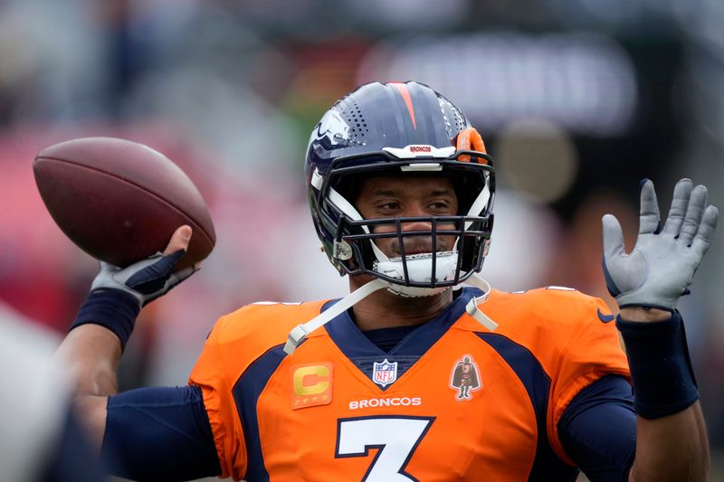 Denver Broncos quarterback Russell Wilson warms up before the start of an NFL football game between the Kansas City Chiefs and the Denver Broncos Sunday, Oct. 29, 2023, in Denver. (AP Photo/David Zalubowski)