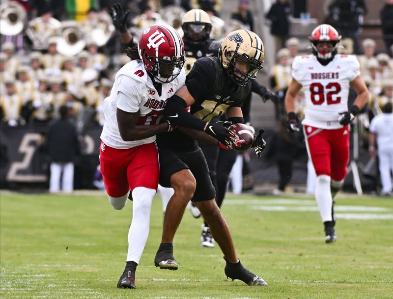 Nov 25, 2023; West Lafayette, Indiana, USA; Purdue Boilermakers defensive back Cam Allen (10) intercepts a pass intended for Indiana Hoosiers wide receiver Andison Coby (0) during the first half at Ross-Ade Stadium. Mandatory Credit: Robert Goddin-USA TODAY Sports