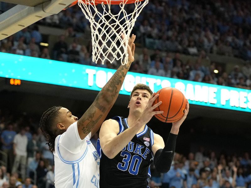 Mar 4, 2023; Chapel Hill, North Carolina, USA;  Duke Blue Devils center Kyle Filipowski (30) shoots as North Carolina Tar Heels forward Armando Bacot (5) defends in the first half at Dean E. Smith Center. Mandatory Credit: Bob Donnan-USA TODAY Sports