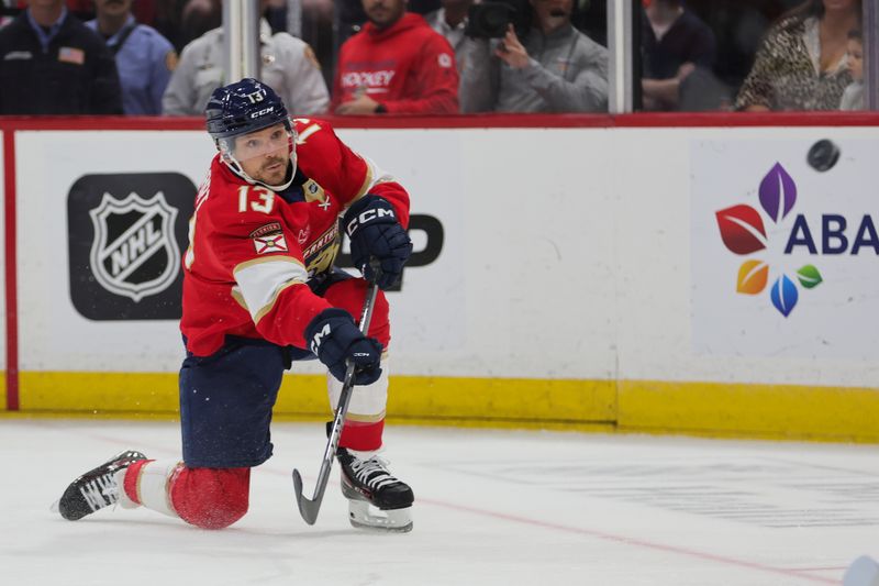 Oct 17, 2024; Sunrise, Florida, USA; Florida Panthers center Sam Reinhart (13) shoots the puck against the Vancouver Canucks during the first period at Amerant Bank Arena. Mandatory Credit: Sam Navarro-Imagn Images