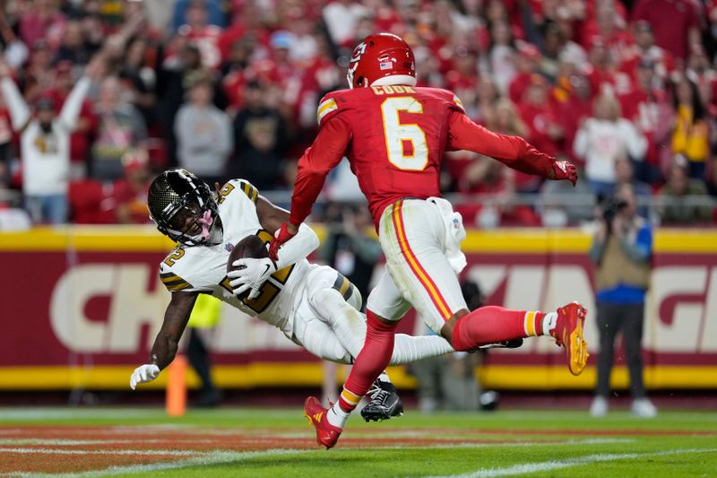 New Orleans Saints Rashid Shaheed, left, catches a touchdown pass as Kansas City Chiefs safety Bryan Cook (6) defends during the first half of an NFL football game Monday, Oct. 7, 2024, in Kansas City, Mo. (AP Photo/Ed Zurga)