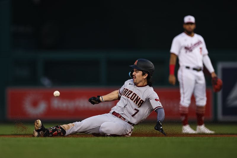 Jun 7, 2023; Washington, District of Columbia, USA; Arizona Diamondbacks left fielder Corbin Carroll (7) attempts to beat the tag of Washington Nationals shortstop CJ Abrams (5) during the fifth inning at Nationals Park.  Corbin Carroll was ruled out on the play. Mandatory Credit: Scott Taetsch-USA TODAY Sports