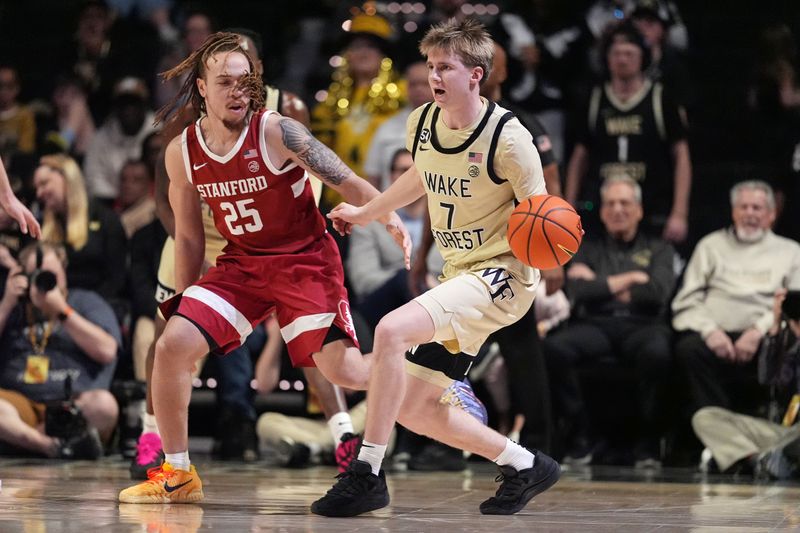 Feb 14, 2026; Winston-Salem, North Carolina, USA; Wake Forest Demon Deacons guard Isaac Carr (7) passes the ball while being defended by Stanford Cardinal guard Jeremy Dent-Smith (25) during the second half at Lawrence Joel Veterans Memorial Coliseum. Mandatory Credit: Jim Dedmon-Imagn Images