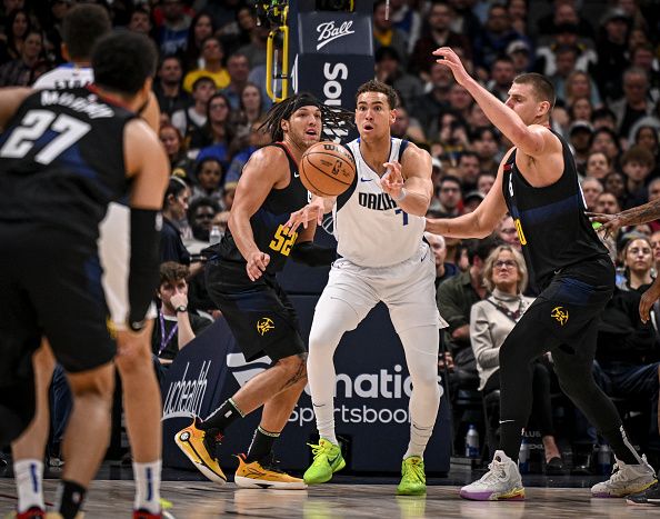 DENVER, CO - DECEMBER 18: Dwight Powell (7) of the Dallas Mavericks kicks the ball out as Nikola Jokic (15) and Aaron Gordon (50) of the Denver Nuggets swarm during the second quarter at Ball Arena in Denver on Monday, December 18, 2023. (Photo by AAron Ontiveroz/The Denver Post)