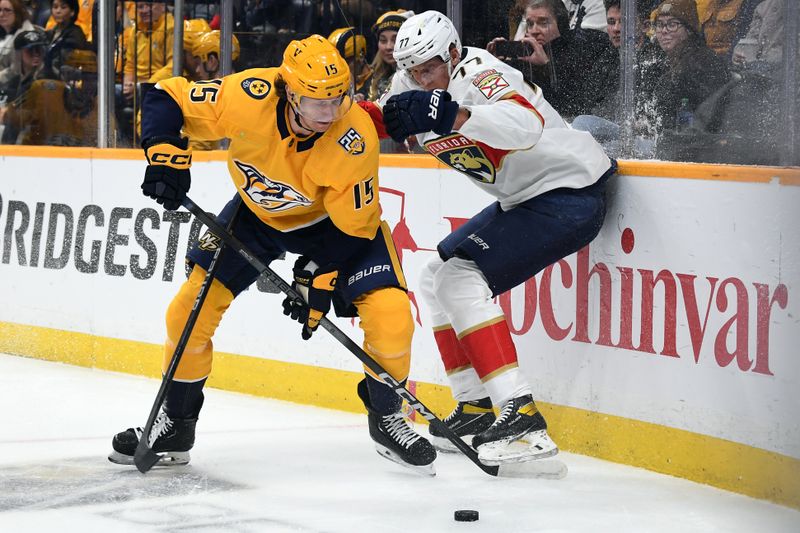 Jan 22, 2024; Nashville, Tennessee, USA; Nashville Predators right wing Denis Gurianov (15) handles the puck against Florida Panthers defenseman Niko Mikkola (77) during the first period at Bridgestone Arena. Mandatory Credit: Christopher Hanewinckel-USA TODAY Sports