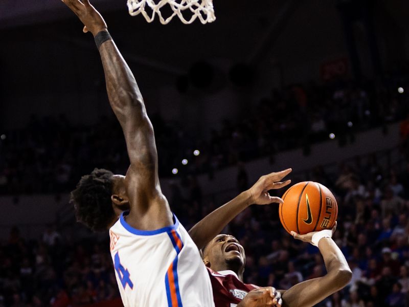 Jan 13, 2024; Gainesville, Florida, USA; Arkansas Razorbacks guard Tramon Mark (12) shoots the ball against Florida Gators forward Tyrese Samuel (4) during the first half at Exactech Arena at the Stephen C. O'Connell Center. Mandatory Credit: Matt Pendleton-USA TODAY Sports