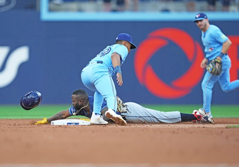 Jul 23, 2024; Toronto, Ontario, CAN; Tampa Bay Rays left fielder Randy Arozarena (56) steals second base ahead of the tag from Toronto Blue Jays shortstop Leo Jiménez (49) during the second inning at Rogers Centre. Mandatory Credit: Nick Turchiaro-USA TODAY Sports