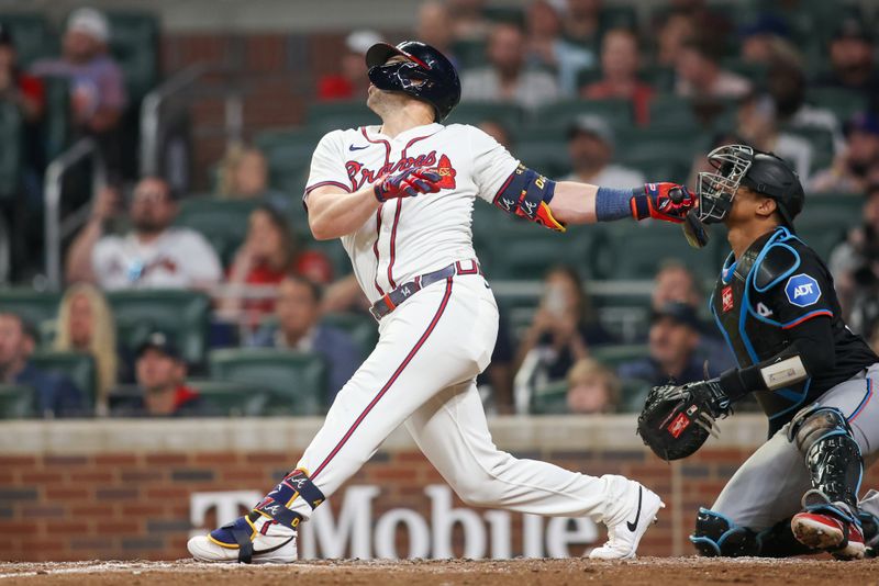 Apr 24, 2024; Atlanta, Georgia, USA; Atlanta Braves left fielder Adam Duvall (14) hits a double against the Miami Marlins in the ninth inning at Truist Park. Mandatory Credit: Brett Davis-USA TODAY Sports