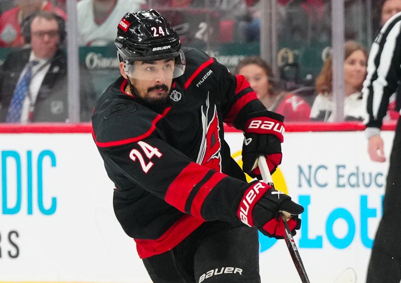 May 12, 2025; Raleigh, North Carolina, USA; Carolina Hurricanes center Seth Jarvis (24) watches his shot against the Washington Capitals during the first period in game four of the second round of the 2025 Stanley Cup Playoffs at Lenovo Center. Mandatory Credit: James Guillory-Imagn Images