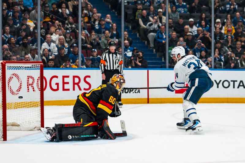 Jan 31, 2026; Vancouver, British Columbia, CAN; Toronto Maple Leafs forward Auston Matthews (34) scores on Vancouver Canucks goalie Nikita Tolopilo (60) during the shootout to win the game for the Maple Leafs at Rogers Arena. Mandatory Credit: Bob Frid-Imagn Images