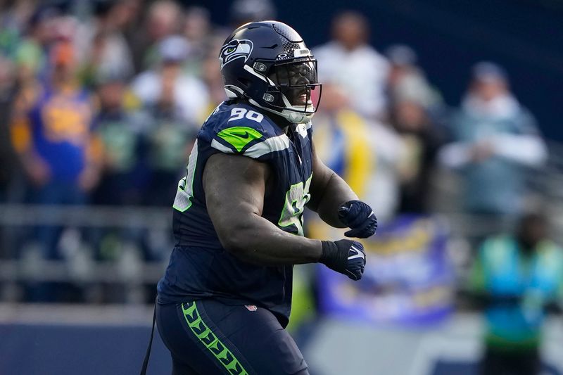 Seattle Seahawks defensive tackle Jarran Reed (90) reacts during the first half of an NFL football game against the Los Angeles Rams in Seattle, Sunday, Nov. 3, 2024. (AP Photo/Lindsey Wasson)