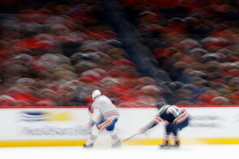 Nov 24, 2023; Washington, District of Columbia, USA;Edmonton Oilers defenseman Cody Ceci (5) and Washington Capitals right wing Nic Dowd (26) chase the puck in the third period at Capital One Arena. Mandatory Credit: Geoff Burke-USA TODAY Sports