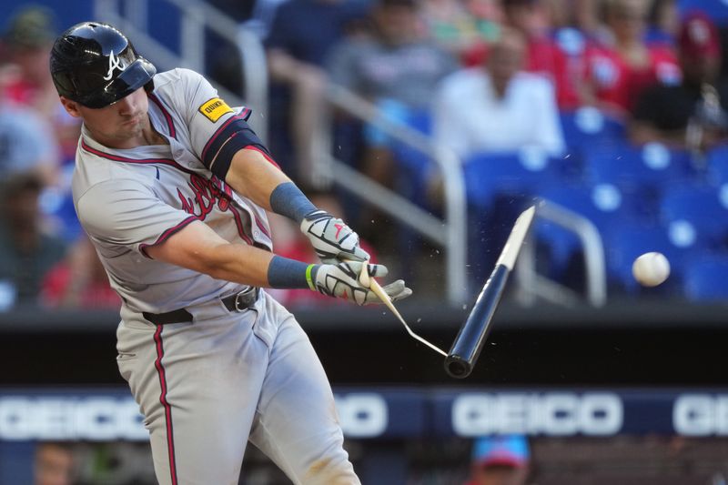 Apr 13, 2024; Miami, Florida, USA;  Atlanta Braves third base Austin Riley (27) shatters his bat in the eight inning against the Miami Marlins at loanDepot Park. Mandatory Credit: Jim Rassol-USA TODAY Sports