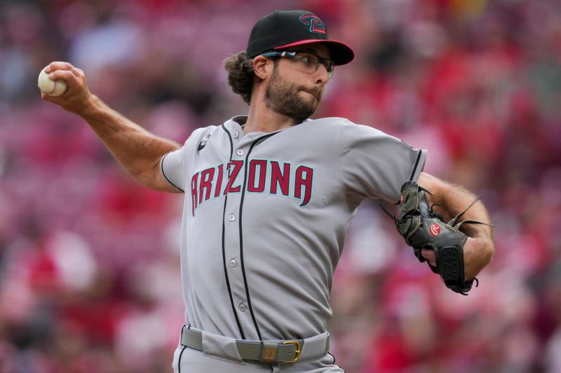 Jun 8, 2025; Cincinnati, Ohio, USA; Arizona Diamondbacks pitcher Zac Gallen (23) throws against the Cincinnati Reds in the sixth inning at Great American Ball Park. Mandatory Credit: Aaron Doster-Imagn Images