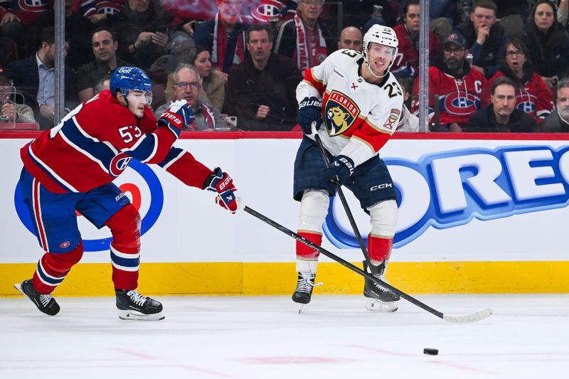 Jan 8, 2026; Montreal, Quebec, CAN; Florida Panthers center Carter Verhaeghe (23) passes the puck against Montreal Canadiens defenseman Noah Dobson (53) during the second period at Bell Centre. Mandatory Credit: David Kirouac-Imagn Images