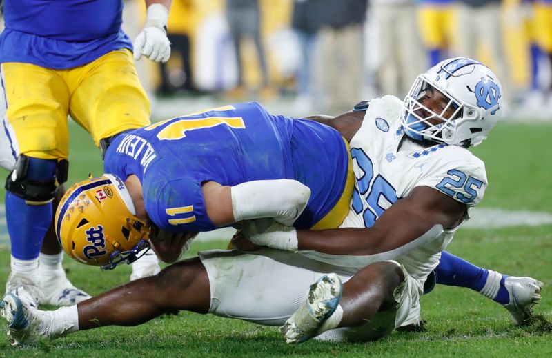 Sep 23, 2023; Pittsburgh, Pennsylvania, USA; North Carolina Tar Heels linebacker Kaimon Rucker (25) sacks Pittsburgh Panthers quarterback Christian Veilleux (11) during the fourth quarter at Acrisure Stadium. The Tar Heels won 41-24. Mandatory Credit: Charles LeClaire-USA TODAY Sports