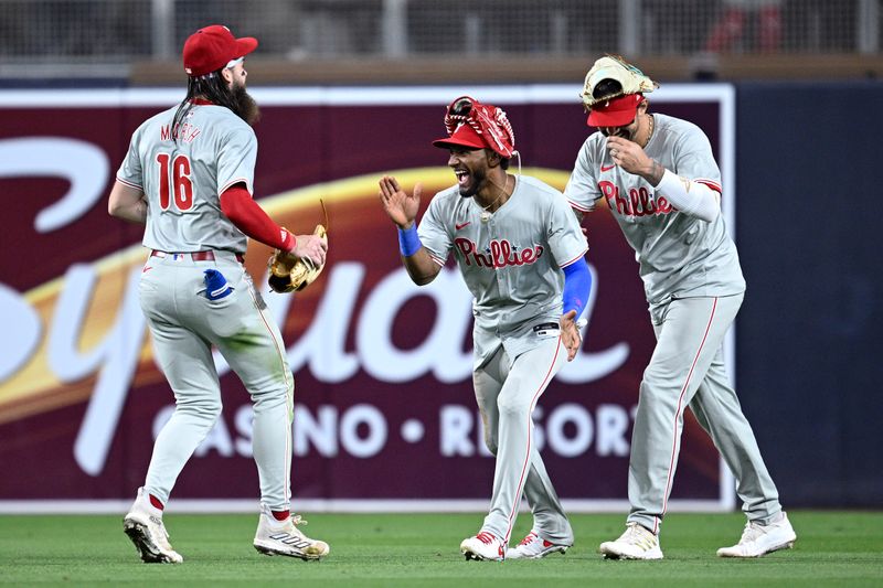 Apr 26, 2024; San Diego, California, USA; Philadelphia Phillies center fielder Johan Rojas (center) celebrates on the field with right fielder Nick Castellanos (8) and left fielder Brandon Marsh (16) after defeating the San Diego Padres at Petco Park. Mandatory Credit: Orlando Ramirez-USA TODAY Sports