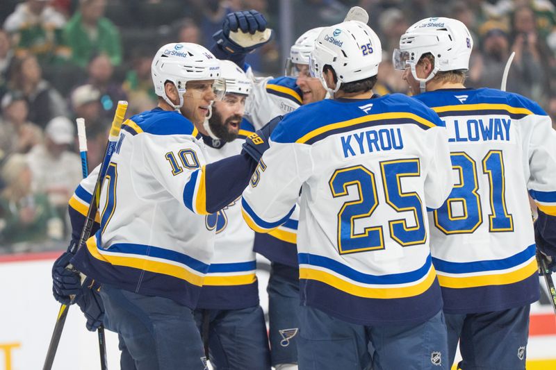 Mar 15, 2025; Saint Paul, Minnesota, USA; St. Louis Blues center Brayden Schenn (10) is congratulated by teammates after scoring on the Minnesota Wild in the first period at Xcel Energy Center. Mandatory Credit: Matt Blewett-Imagn Images