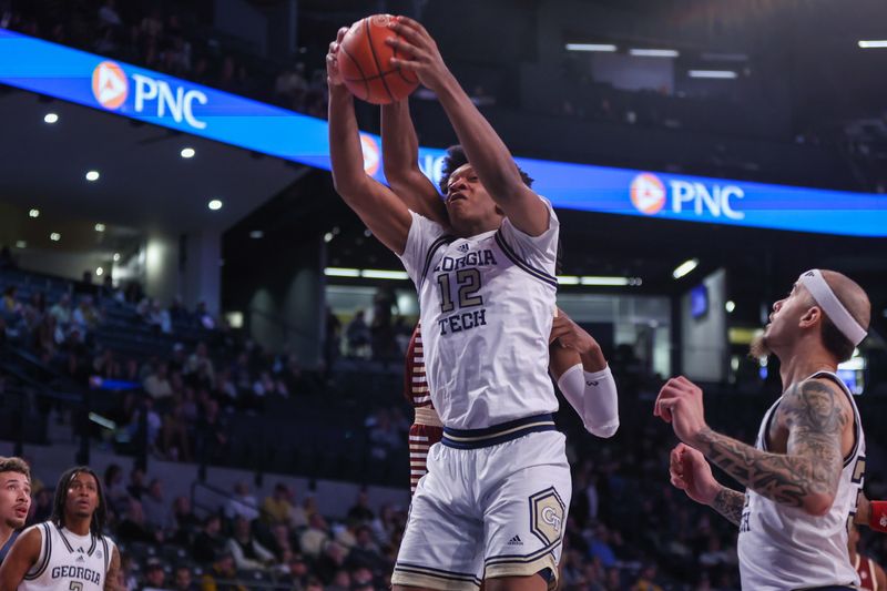 Jan 4, 2025; Atlanta, Georgia, USA; Georgia Tech Yellow Jackets center Ryan Mutombo (12) grabs a rebound against the Boston College Eagles in the first half at McCamish Pavilion. Mandatory Credit: Brett Davis-Imagn Images