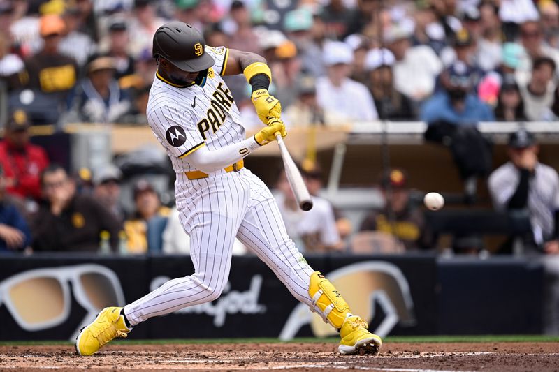 May 15, 2024; San Diego, California, USA; San Diego Padres left fielder Jurickson Profar (10) hits a single against the Colorado Rockies during the fourth inning at Petco Park. Mandatory Credit: Orlando Ramirez-USA TODAY Sports