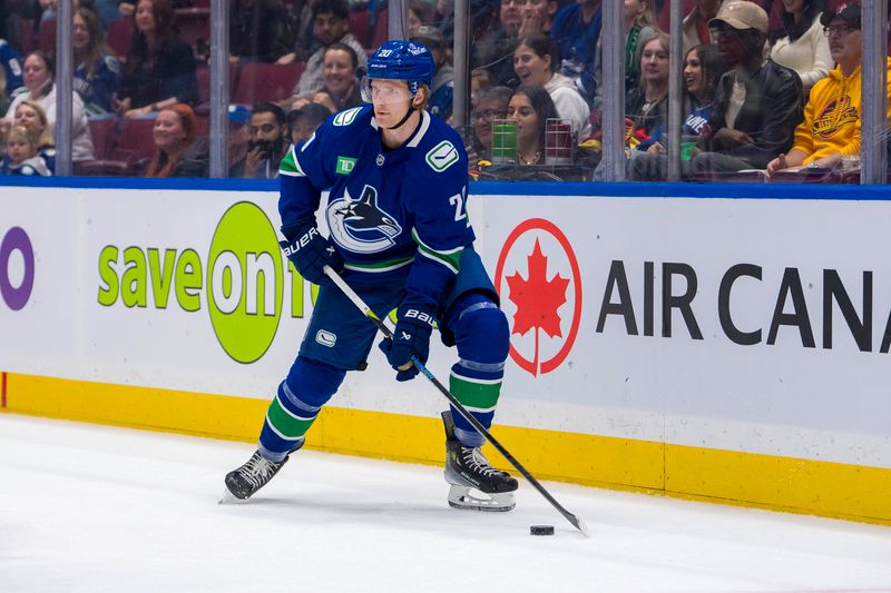 Sep 24, 2024; Vancouver, British Columbia, CAN; Vancouver Canucks forward Danton Heinen (20) handles the puck against the Seattle Kraken during the first period at Rogers Arena. Mandatory Credit: Bob Frid-Imagn Images