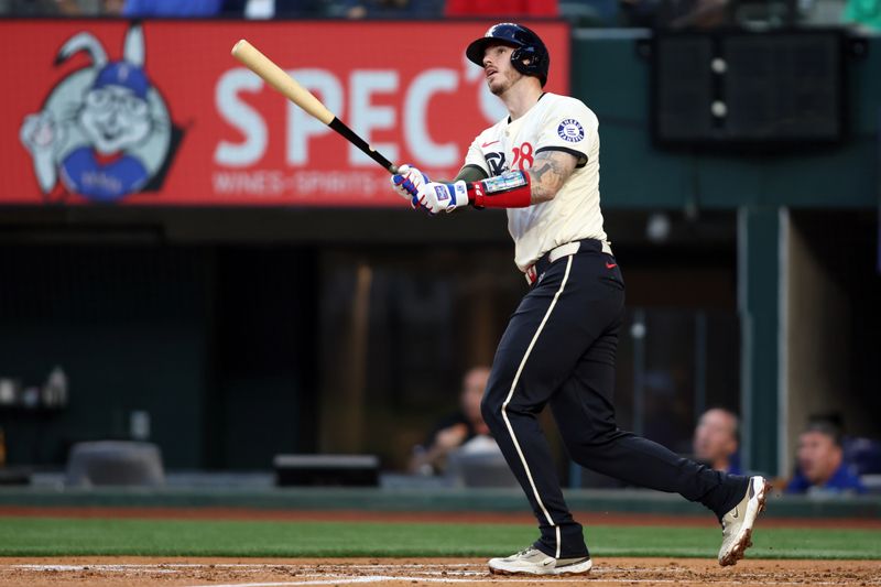 May 17, 2024; Arlington, Texas, USA; Texas Rangers catcher Jonah Heim (28) hits a home run in the second inning against the Los Angeles Angels at Globe Life Field. Mandatory Credit: Tim Heitman-USA TODAY Sports