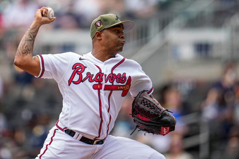 May 21, 2023; Cumberland, Georgia, USA; Atlanta Braves relief pitcher Raisel Iglesias (26) pitches against the Seattle Mariners during the ninth inning at Truist Park. Mandatory Credit: Dale Zanine-USA TODAY Sports