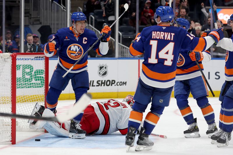 Jan 25, 2025; Elmont, New York, USA; New York Islanders left wing Anders Lee (27) celebrates his game tying goal against Carolina Hurricanes goaltender Pyotr Kochetkov (52) during the third period at UBS Arena. Mandatory Credit: Brad Penner-Imagn Images