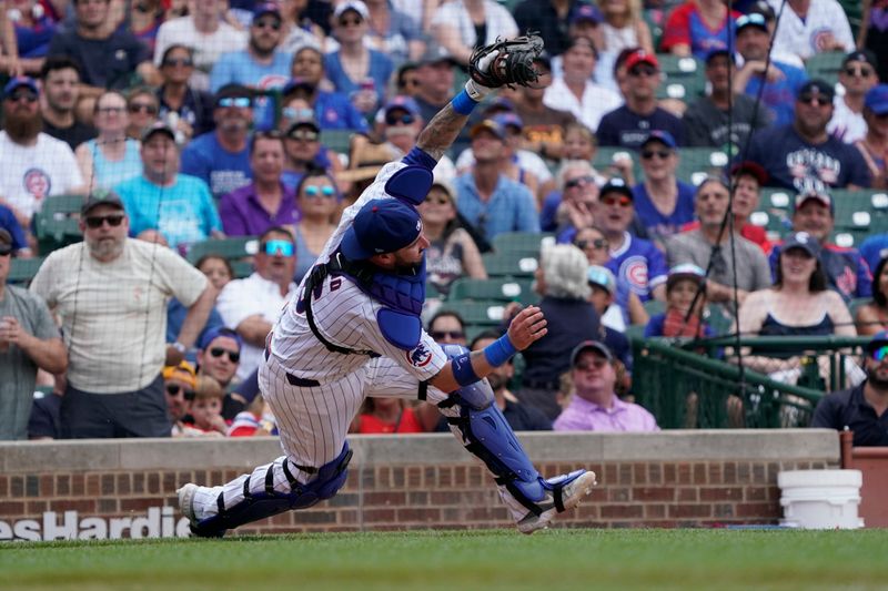 Jun 22, 2024; Chicago, Illinois, USA; Chicago Cubs catcher Tomás Nido (6) catches ball hit by New York Mets outfielder DJ Stewart (not pictured ) during the ninth inning at Wrigley Field. Mandatory Credit: David Banks-USA TODAY Sports