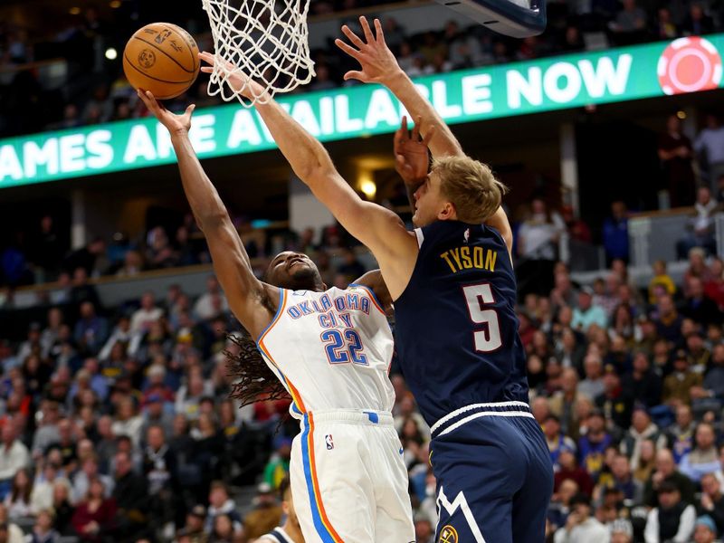 DENVER, COLORADO - NOVEMBER 6: Cason Wallace #22 of the Oklahoma City Thunder drives against Hunter Tyson #5 of the Denver Nuggets in the second half at Ball Arena on November 6, 2024 in Denver, Colorado. NOTE TO USER: User expressly acknowledges and agrees that, by downloading and/or using this Photograph, user is consenting to the terms and conditions of the Getty Images License Agreement. (Photo by Jamie Schwaberow/Getty Images)