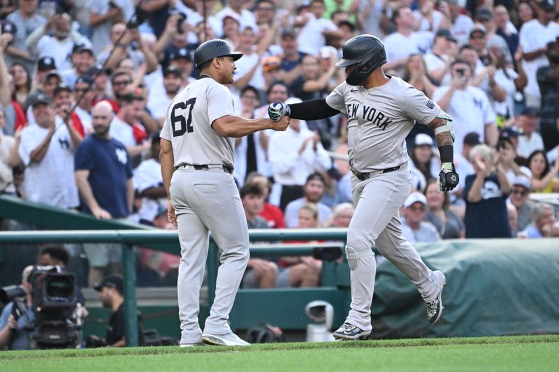 Aug 26, 2024; Washington, District of Columbia, USA; New York Yankees second baseman Gleyber Torres (25) celebrates hitting a home run with third base coach Luis Rojas (67) against the Washington Nationals during the first inning at Nationals Park. Mandatory Credit: Rafael Suanes-USA TODAY Sports