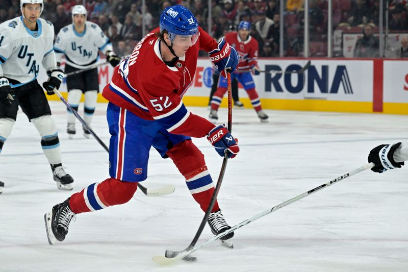 Nov 26, 2024; Montreal, Quebec, CAN; Montreal Canadiens defenseman Justin Barron (52) shoots during the first period against the Utah Hockey Club at the Bell Centre. Mandatory Credit: Eric Bolte-Imagn Images