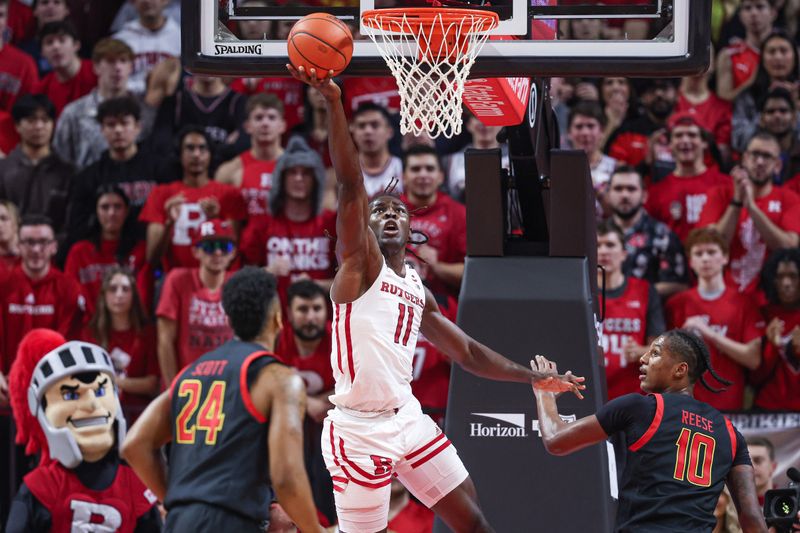 Jan 5, 2023; Piscataway, New Jersey, USA; Rutgers Scarlet Knights center Clifford Omoruyi (11) shoots the ball against Maryland Terrapins forward Donta Scott (24) and forward Julian Reese (10) during the first half at Jersey Mike's Arena. Mandatory Credit: Vincent Carchietta-USA TODAY Sports