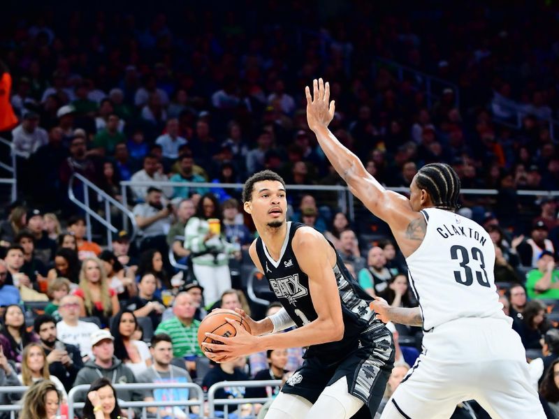 AUSTIN, TX - MARCH 17: Victor Wembanyama #1 of the San Antonio Spurs handles the ball against Nicolas Claxton #33 of the Brooklyn Nets during the game on March 17, 2024 at the Moody Center in Austin, Texas. NOTE TO USER: User expressly acknowledges and agrees that, by downloading and or using this photograph, user is consenting to the terms and conditions of the Getty Images License Agreement. Mandatory Copyright Notice: Copyright 2024 NBAE (Photos by Michael Gonzales/NBAE via Getty Images)