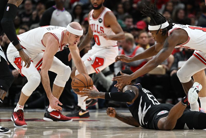 CHICAGO, ILLINOIS - JANUARY 31: Paul George #13 of the LA Clippers loses the basketball to Alex Caruso #6 of the Chicago Bulls in the first half at United Center on January 31, 2023 in Chicago, Illinois. NOTE TO USER: User expressly acknowledges and agrees that, by downloading and or using this photograph, User is consenting to the terms and conditions of the Getty Images License Agreement.  (Photo by Quinn Harris/Getty Images)