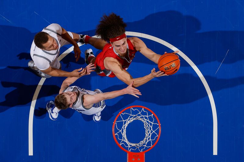 Feb 10, 2023; Colorado Springs, Colorado, USA; New Mexico Lobos forward Josiah Allick (53) drives to the net against Air Force Falcons guard Jake Heidbreder (3) and guard Corbin Green (15) in the first half at Clune Arena. Mandatory Credit: Isaiah J. Downing-USA TODAY Sports