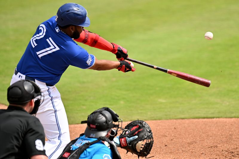 Feb 26, 2026; Dunedin, Florida, USA; Toronto Blue Jays first baseman Vladimir Guerrero Jr. (27) hits a RBI double in the second inning against the Florida Marlins during spring training at TD Ballpark. Mandatory Credit: Jonathan Dyer-Imagn Images