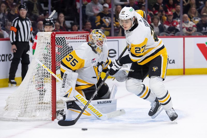 Mar 12, 2024; Ottawa, Ontario, CAN; Pittsburgh Penguins defenseman Ryan Graves (27) moves the puck away from goalie Tristan Jarry (35) in the first period against the Ottawa Senators at the Canadian Tire Centre. Mandatory Credit: Marc DesRosiers-USA TODAY Sports