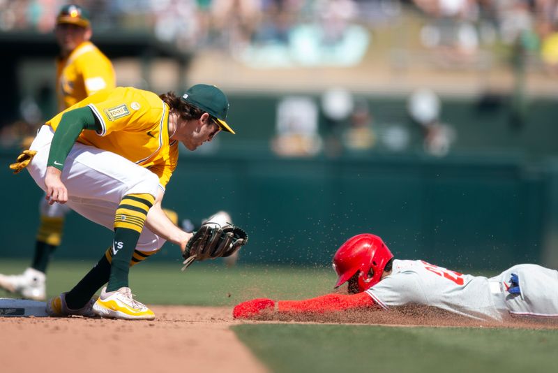 May 25, 2025; West Sacramento, California, USA; Athletics shortstop Jacob Wilson (5) puts the tag on Philadelphia Phillies pinch runner Johan Rojas (23) as he attempts to steal second base during the ninth inning at Sutter Health Park. Mandatory Credit: D. Ross Cameron-Imagn Images