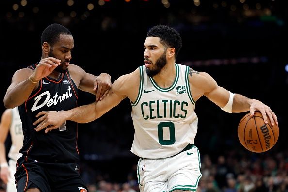 Boston, MA - December 28: Boston Celtics SF Jayson Tatum drives against Detroit Pistons SG Alec Burks. The Celtics beat the Pistons, 128-122, in overtime. (Photo by Danielle Parhizkaran/The Boston Globe via Getty Images)